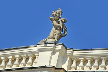 One of the 16 figures of the Cupid Babies on the balustrade of the Odessa Opera House in Ukraine against the skyのeditorial素材