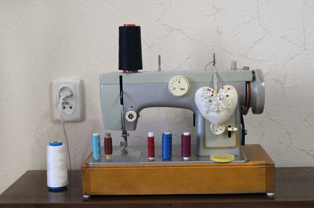 Electric sewing machine with sewing accessories on table.