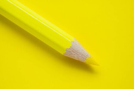 Macro photo of yellow pencil on yellow paperの写真素材
