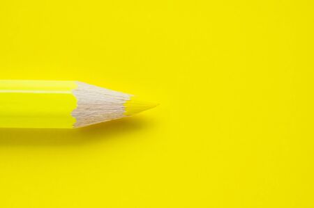 Macro photo of yellow pencil on yellow paperの写真素材