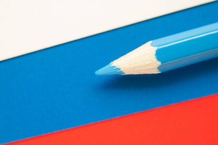 Blue pencil on Russian flag background. Macro photo.の写真素材