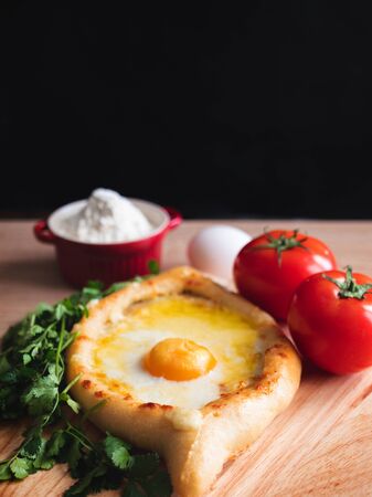 Khachapuri in Adjarian. Open pie with mozzarella and egg. Georgian cuisine.の写真素材