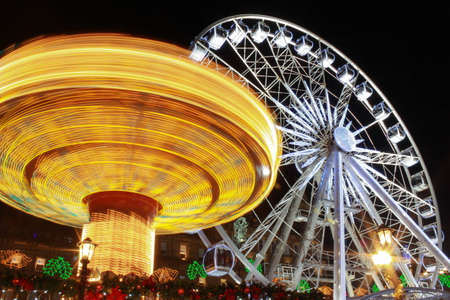 The fair in motion six and big wheel, George Sqaure, Glasgow, Scotland, part of the Christmas and Hogmanay holiday attractions, at nightの写真素材