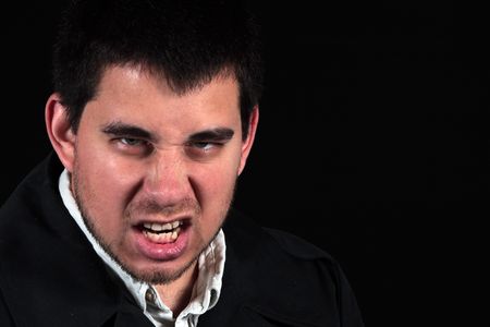 angry male protrait isolated on black background with room for copy spaceの写真素材