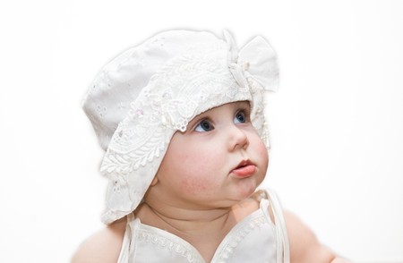 10 months old girl in nice dress and hat on whiteの写真素材