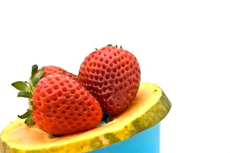 Photo of strawberries on slice of papayaの写真素材