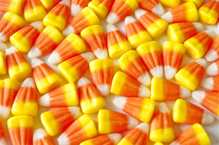 Layer of candy corns on a white background