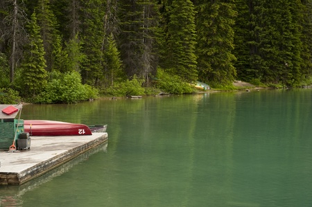 Boat dock with a canoe on a mountain lakeの写真素材