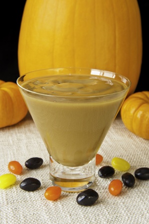 Dish of Butterscotch pudding with jellybeans and pumpkinsの写真素材