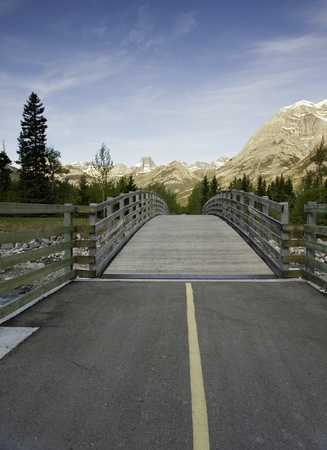 Wooden bridge on a bike trail through the mountainsの写真素材