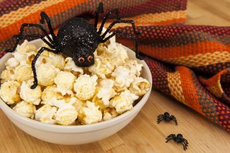 Dish of popcorn with Halloween spidersの写真素材