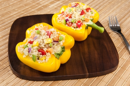 Two yellow peppers stuffed with quinoa and mixed vegetablesの写真素材