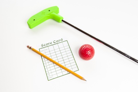 Green mini golf club with score card, pencil  and red ballの写真素材