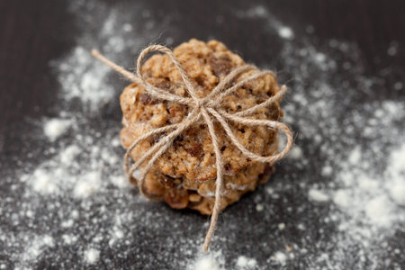 oatmeal cookies with raisins and flour on wooden table