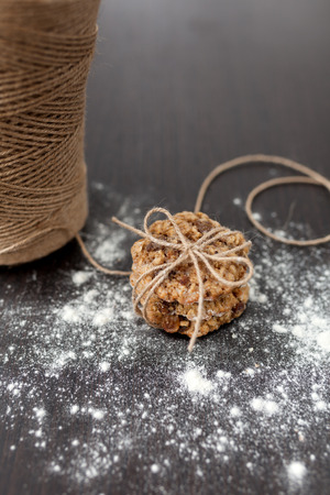 oatmeal cookies with raisins and flour on wooden tableの写真素材
