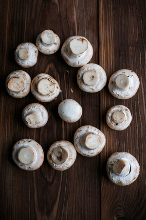White mushrooms on brown wood tableの写真素材