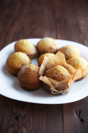 Homemade muffins in plate on old wood tableの写真素材