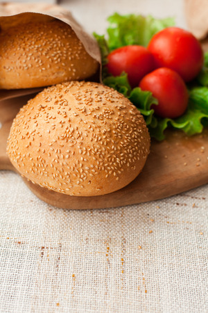 Hamburger ingredients on wood tableの写真素材
