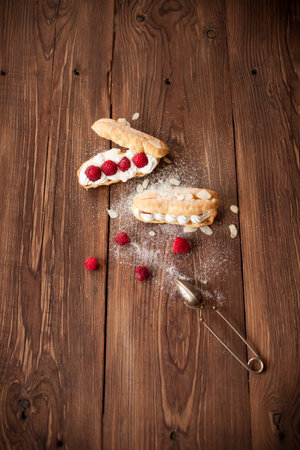 Sweet dessert with fresh raspberries on old wood table