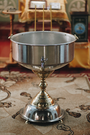 Silver bath for baptism ceremony inside church with decoration closeupの写真素材