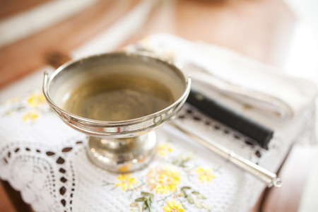 Church silver bowl for ceremony on table inside church blur backgroundの写真素材