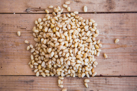 Batch of shelled pine nuts on the wooden table
