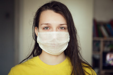 Portrait of young girl with ear loop face mask, close up