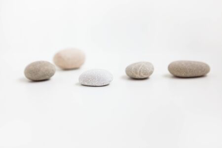 Set of five pebbles isolated on the white backgroundの写真素材