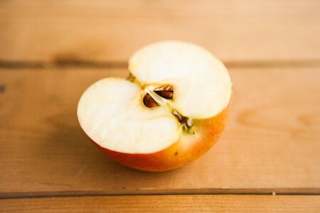 Half of apple on the chocolate backgroundの写真素材
