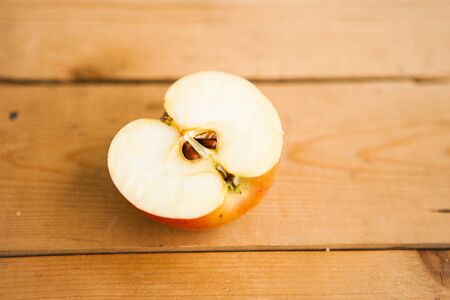 Half of apple on the chocolate backgroundの写真素材