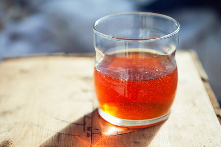 Honey in cup on wooden tableの写真素材