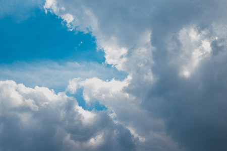 Clouds in the dark sky. Sunlight through the clouds