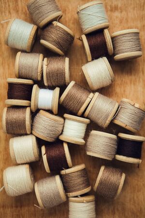 Set of thread on wooden background, flat lay, top viewの写真素材