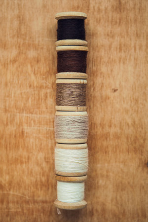 Set of thread on wooden background with copy space for your texture background with copy space for...