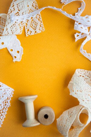 White laces on yellow background with the copy space for your textの写真素材