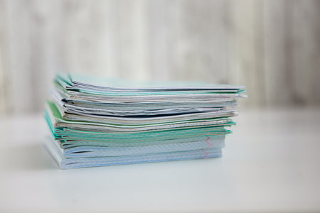 Stock of green exersice books on the light background