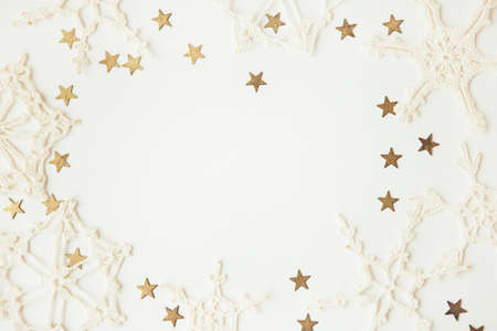 White snowflakes and gold stars on white background, copy space for textの写真素材