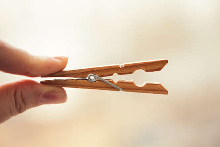 Wooden clothespin pegs for hanging photos and decorations, close up.の写真素材