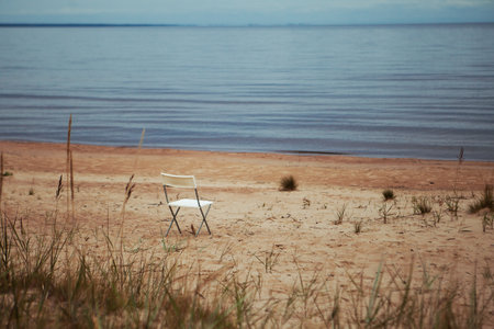 White chair on the beach of the Sea. Selective focus. Lake landscapeの写真素材