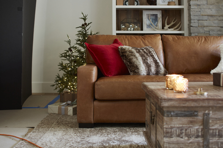 Here is a more cozy space filled with pillow backed L-shape sectional couchの写真素材