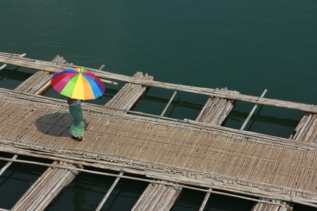 bamboo raft bridge of Sangkhlaburi, Thailand is a attracion. Tourists visitの写真素材