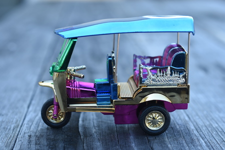 Colorful Tuk Tuk Model on wooden backgroundの写真素材