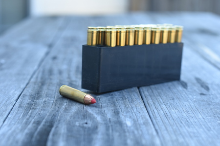 Red tip 450 Caliber ammunition on wooden backgroundの写真素材