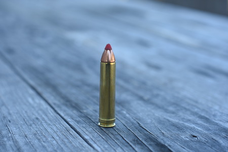 Red tip ammunition on wooden backgroundの写真素材