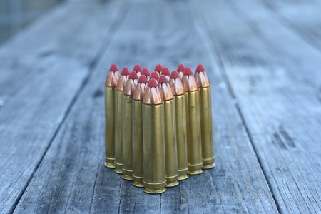Red tip ammunition on wooden backgroundの写真素材