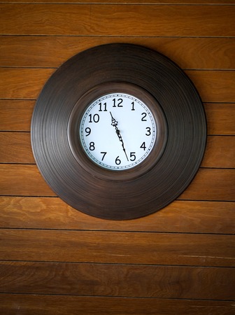 wall clock on wooden backgroundの写真素材
