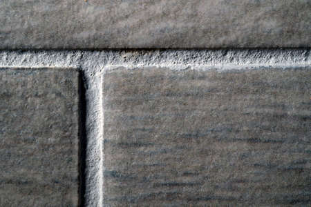 stone ceramic glued tiles seams close-up macro texture backgroundの写真素材