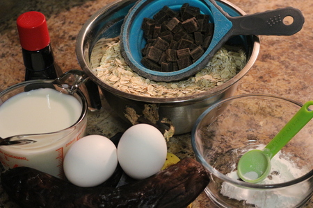 Baking ingredients for chocolate cake muffins or cookies lying ready on wooden kitchen tray. Mise en place, white background, measured ingredients.の写真素材