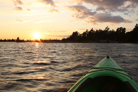 Sunset on Georgian Bay at Parry Sound view from kayak with ripples in the waterの写真素材