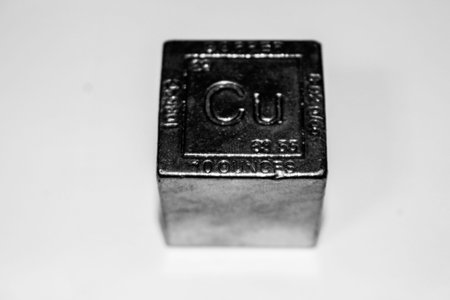 copper cube that is worth nothing on a white background